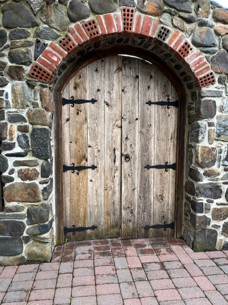 A weathered door in a stone wall.